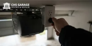 Homeowner plugging in garage door opener to reset it after a power outage