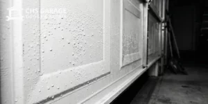 Water condensation droplets on interior of steel garage door panel in Seattle
